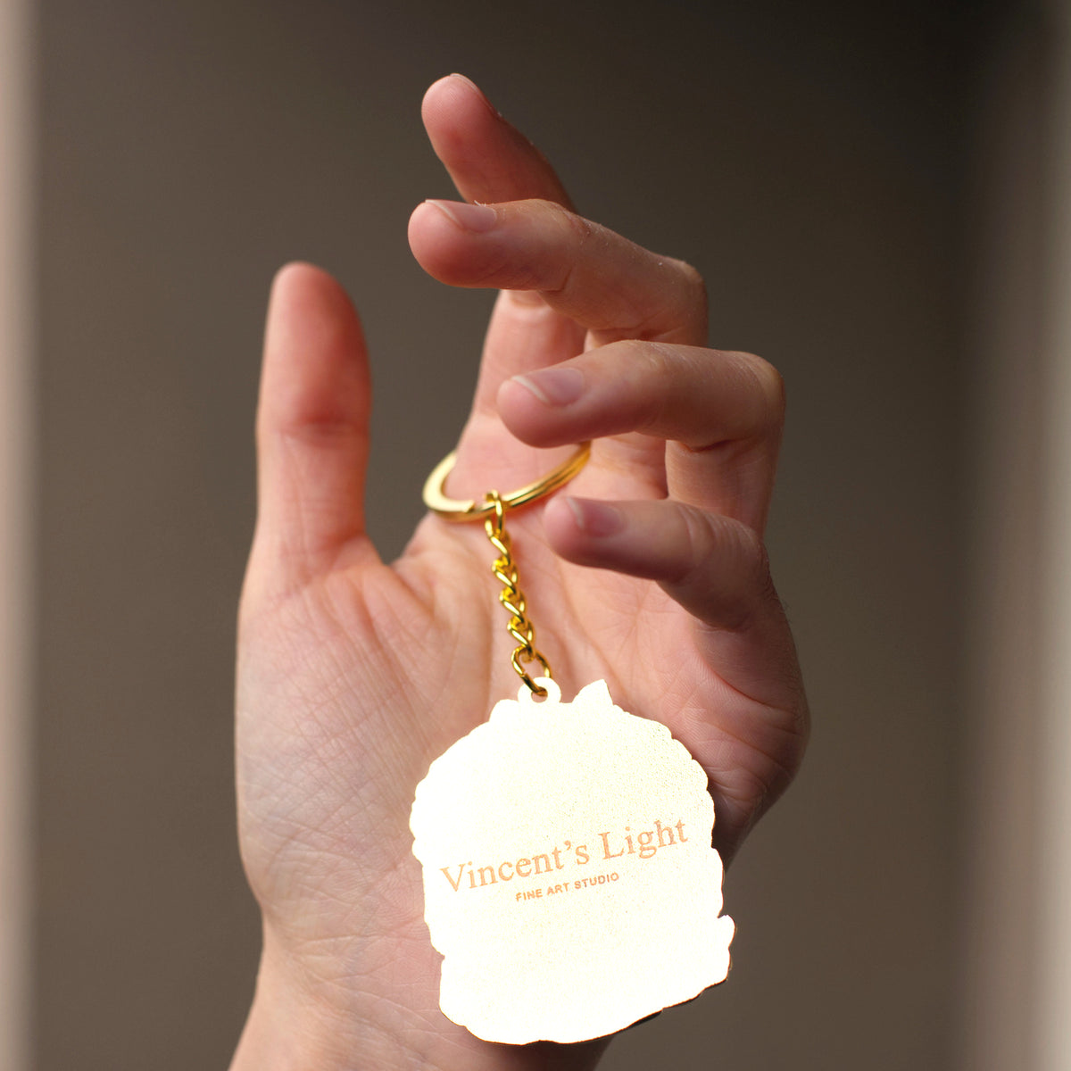 Back of the keychain with the Vincent's Light logo
