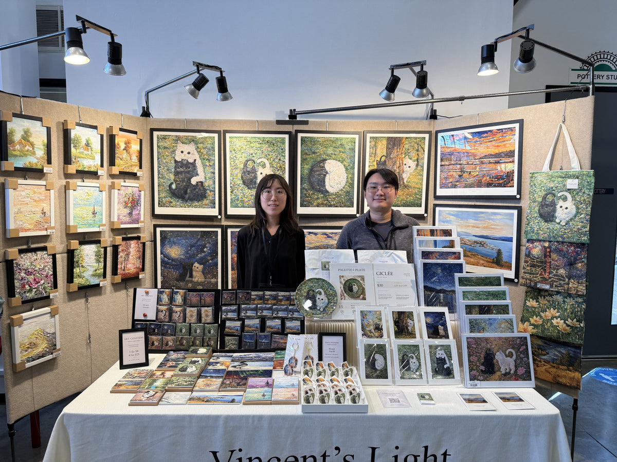 Our booth at a market, set up like a small gallery with original paintings on the walls