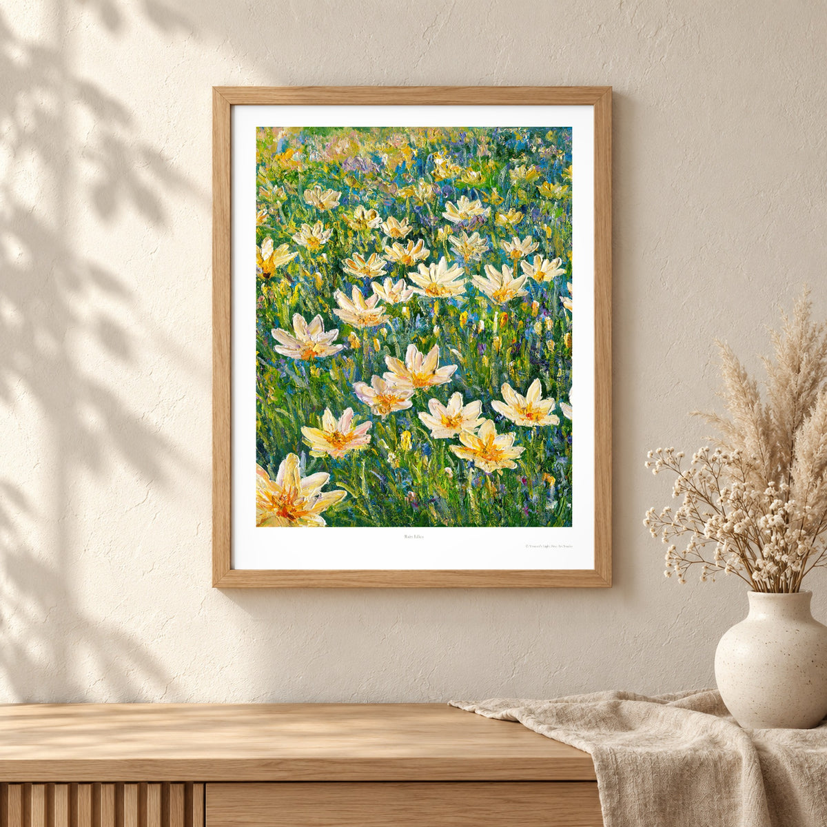 Rain Lilies art print shown in an oak frame on a wall (frame not included)