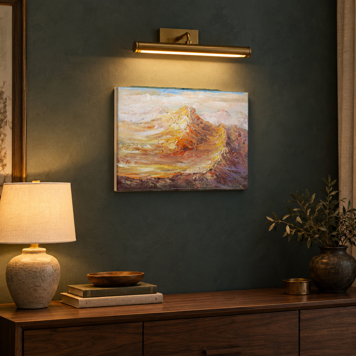 Afterglow Ridge by Yingzhi Chen hanging on a deep teal-grey limewash wall above a walnut console with a ceramic lamp and a stack of books