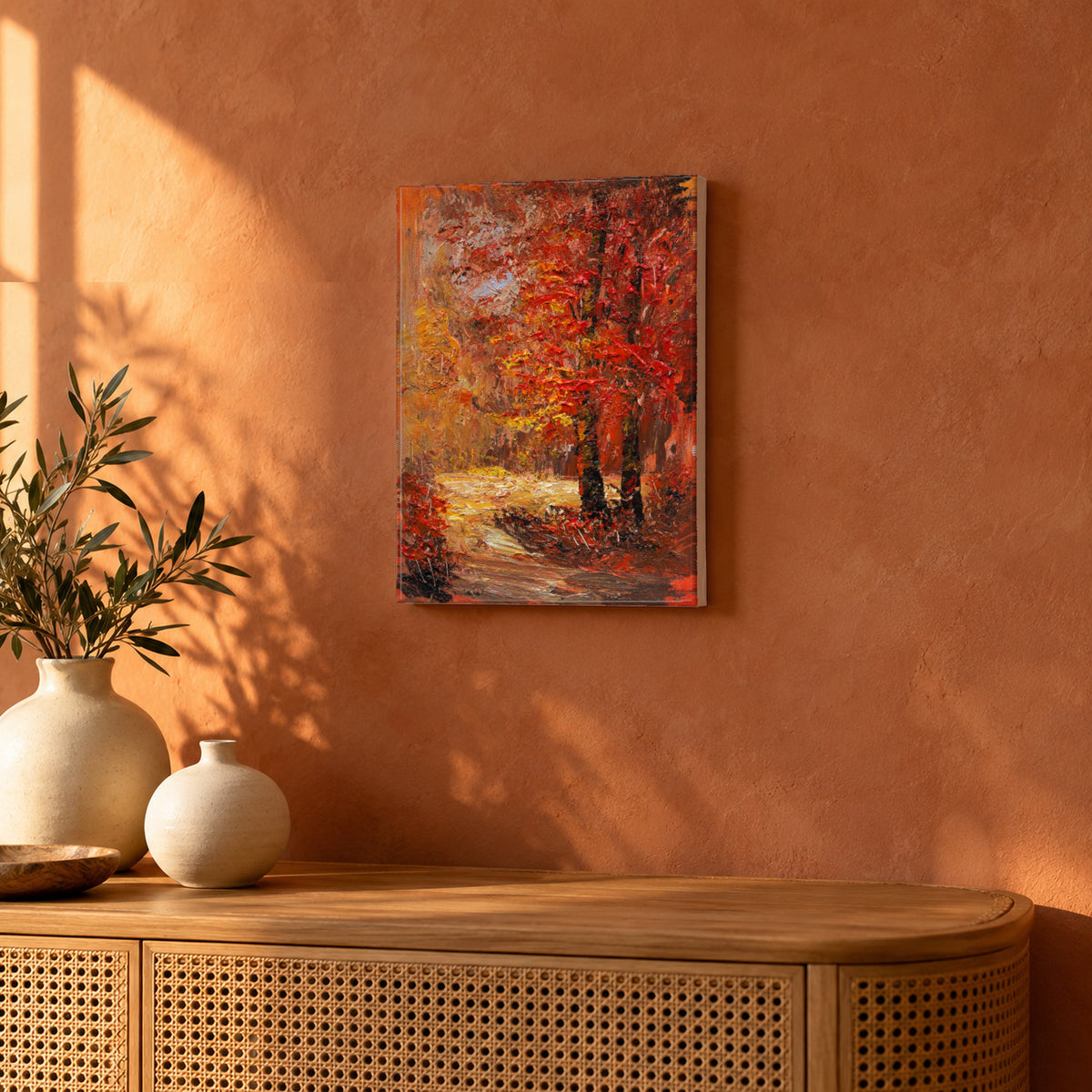 Autumn Ember by Yingzhi Chen hanging on a terracotta clay limewash wall above a low rattan console with two cream ceramic vases