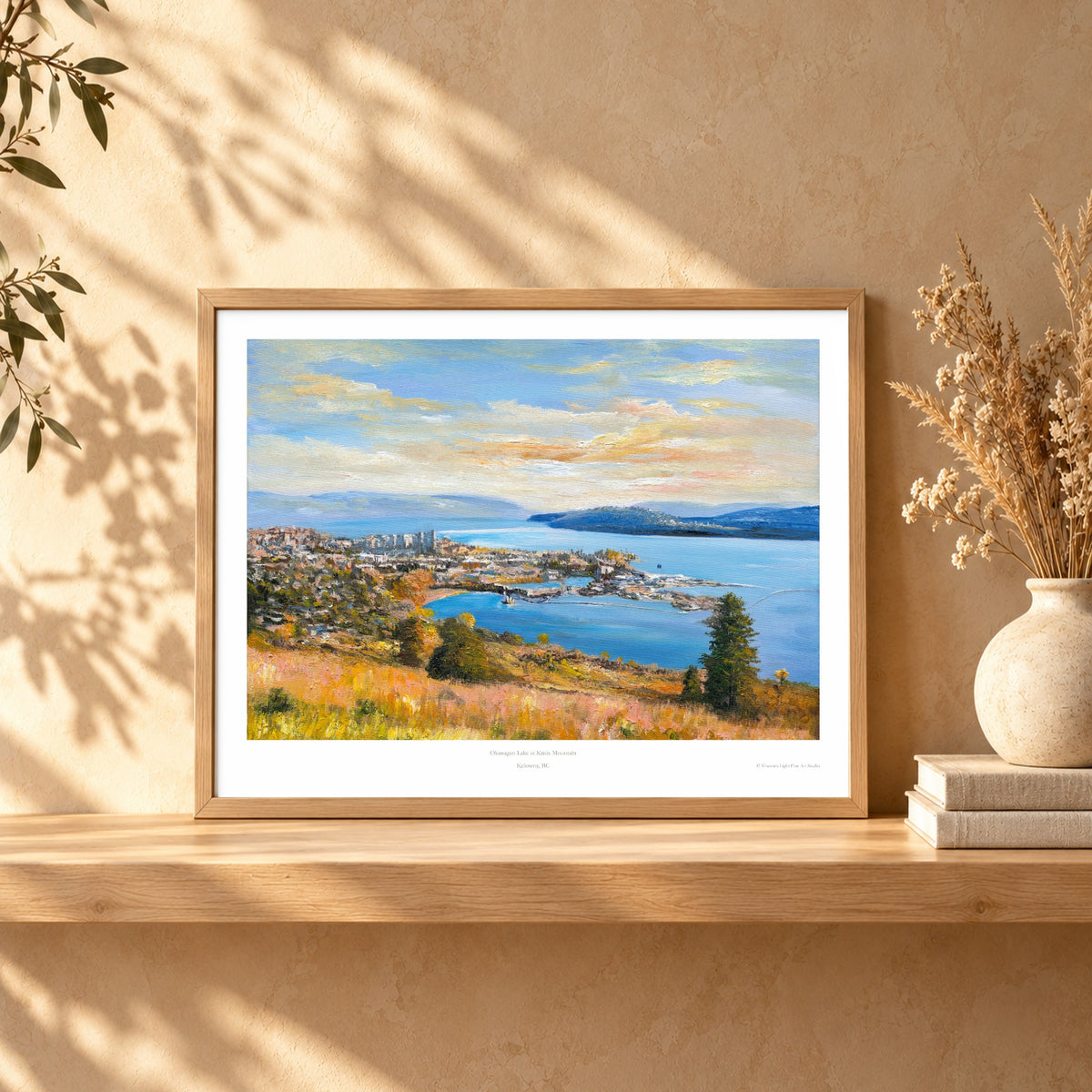 Art print in a light oak frame on a shelf
