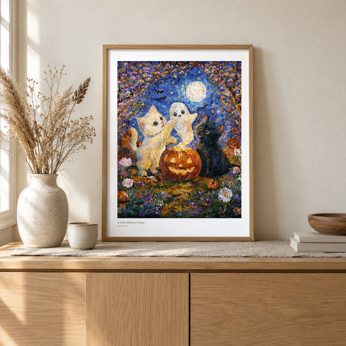 A Little Halloween Magic studio print, 17 × 22 in, in a light oak frame on a sideboard (frame not included)