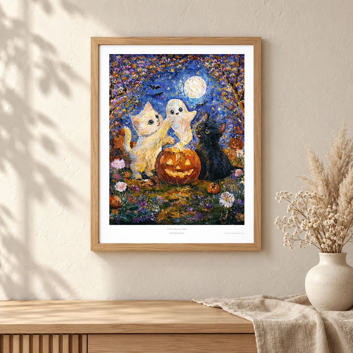 A Little Halloween Magic art print shown in an oak frame on a wall (frame not included)