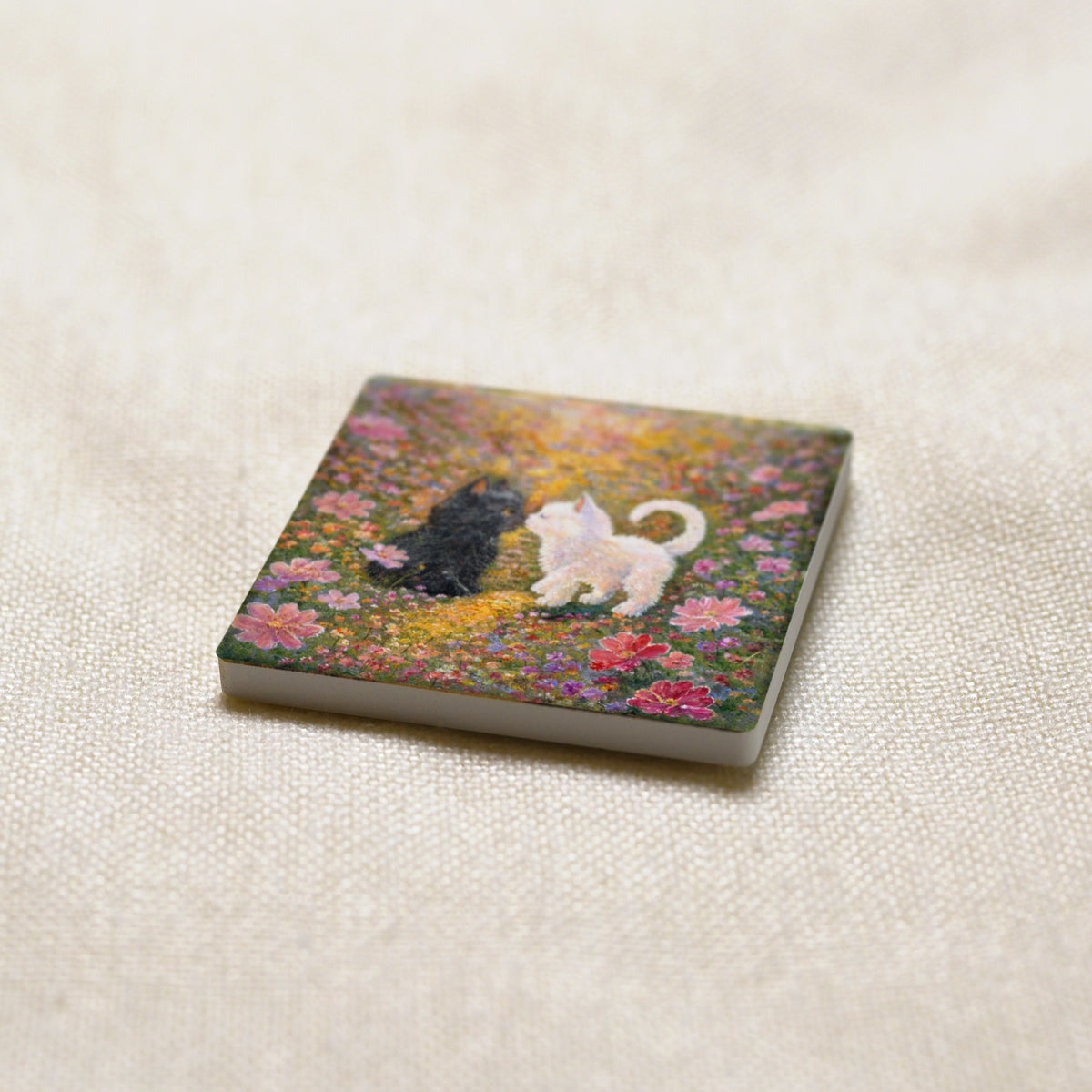 Little Nose Kiss art magnet at an angle, showing the stone edge