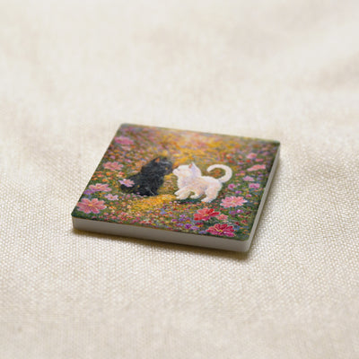 Little Nose Kiss art magnet at an angle, showing the stone edge