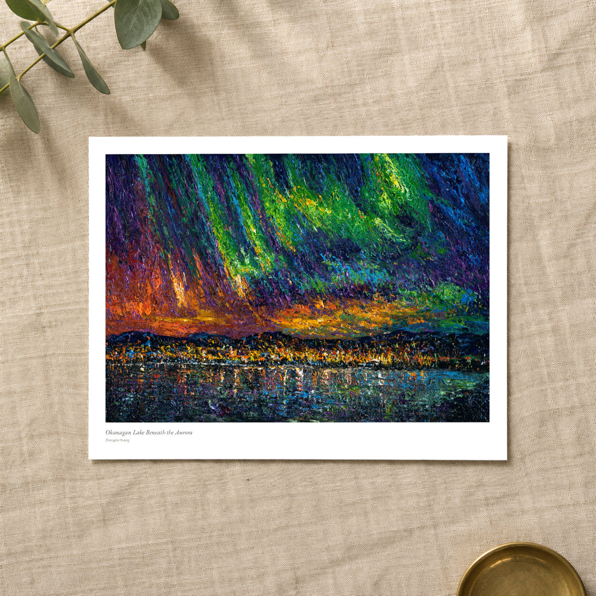 Okanagan Lake Beneath the Aurora studio print with title and signature margin, lying on linen