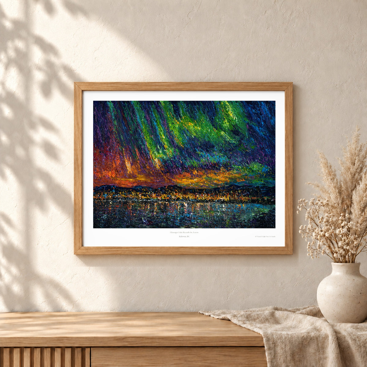 Okanagan Lake Beneath the Aurora art print shown in an oak frame on a wall (frame not included)