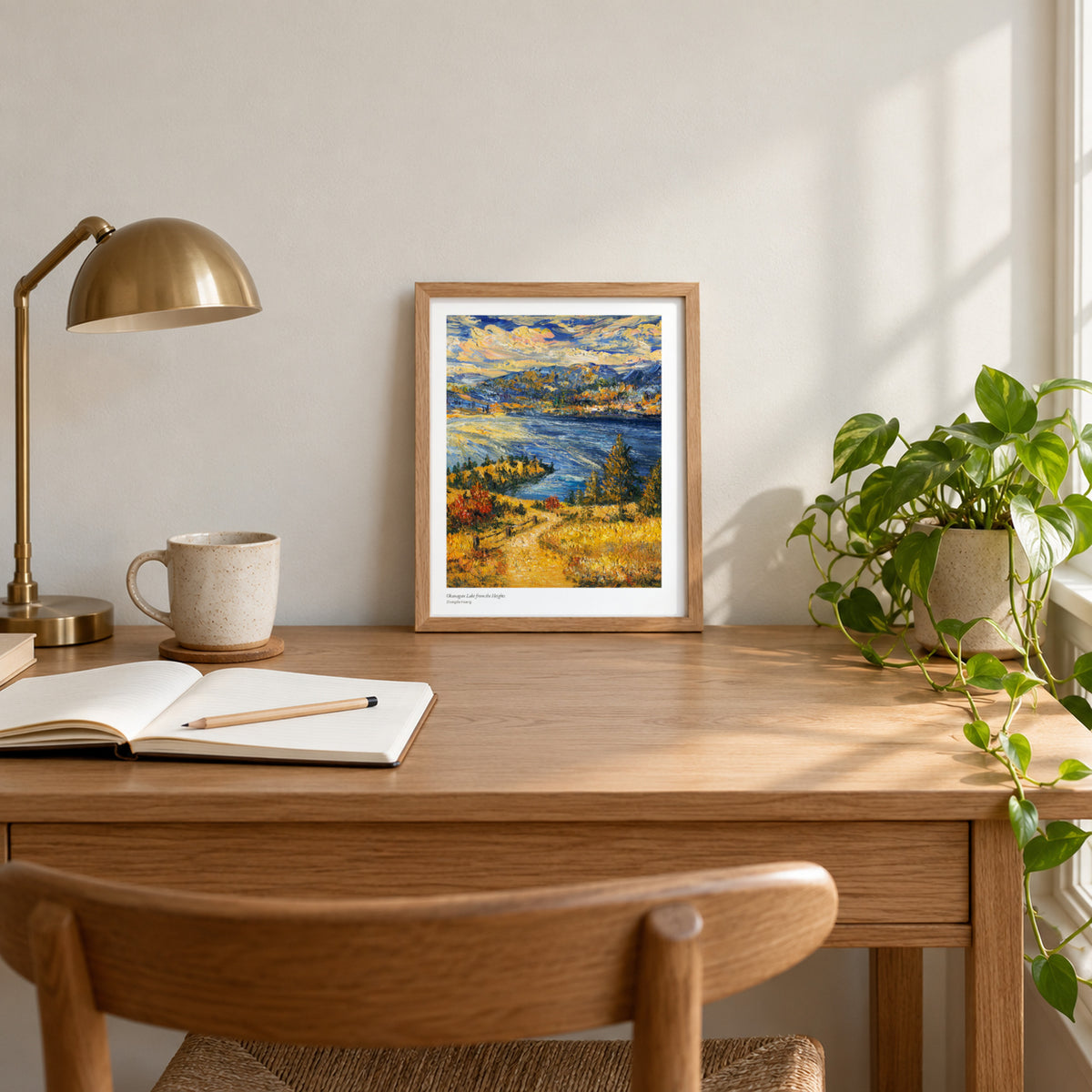 Okanagan Lake from the Heights studio print, 8.5 × 11 in, in a light oak frame on a desk (frame not included)