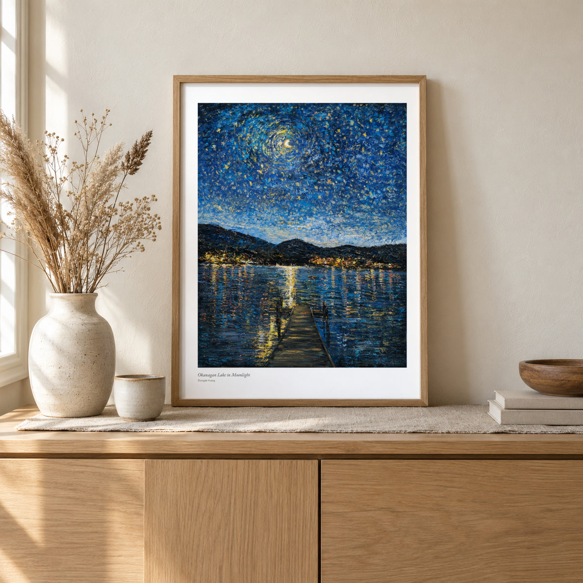Okanagan Lake in Moonlight studio print, 17 × 22 in, in a light oak frame on a sideboard (frame not included)