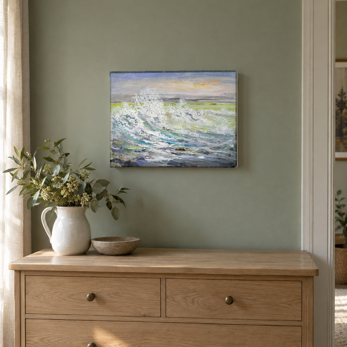 Breaking Waves by Yingzhi Chen hanging on a sage green painted wall above a pale oak dresser with a white ceramic jug of fresh greenery