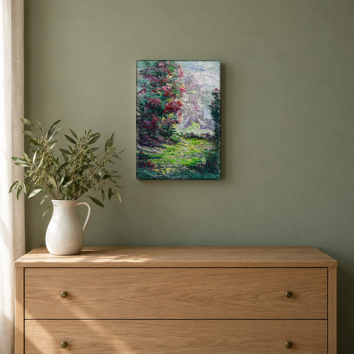 Where Color Leads by Yingzhi Chen hanging on a sage green painted wall above a pale oak dresser with a white ceramic jug of fresh greenery